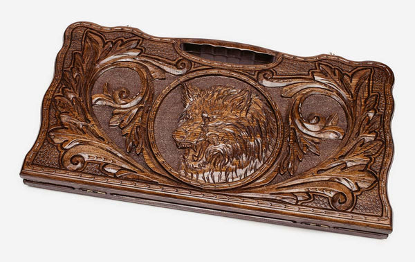 Carved beechwood backgammon board with a lone wolf and a carry handle, propped open