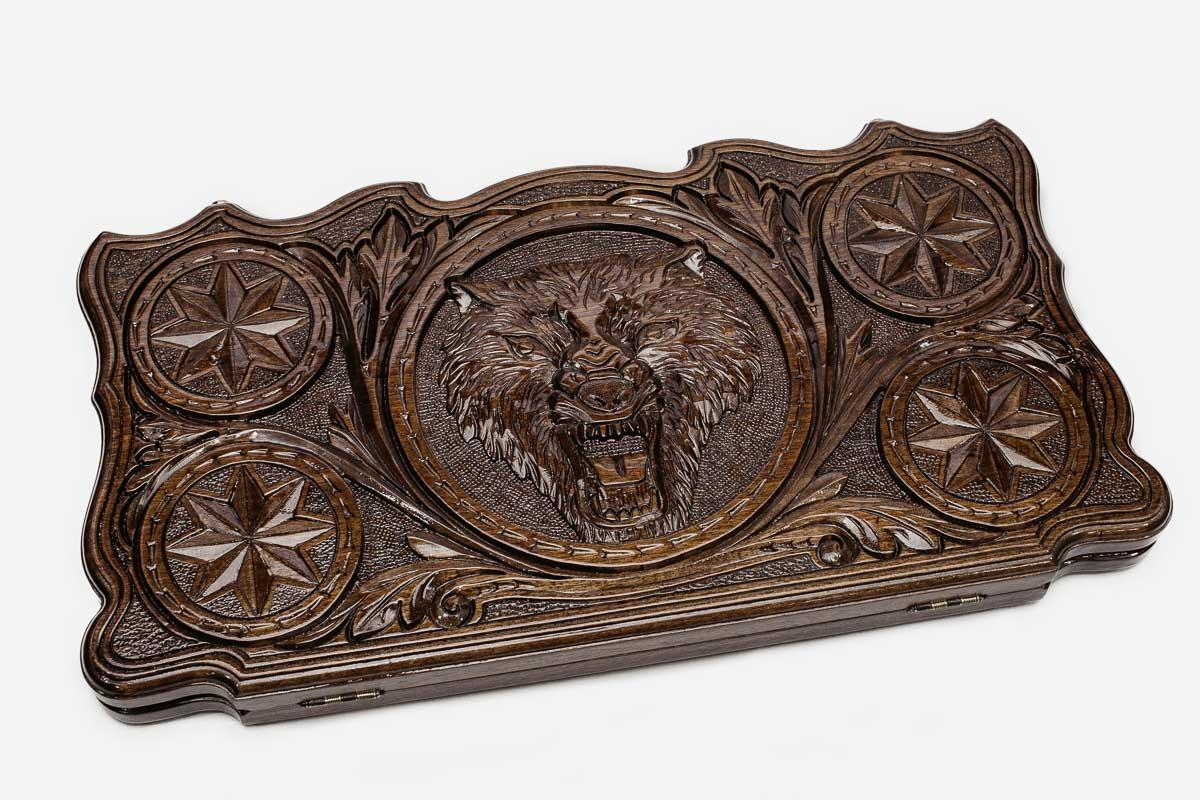 Lone wolf carved on the walnut backgammon board face