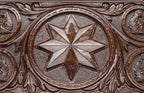 Close-up of the carved wolf in dark walnut
