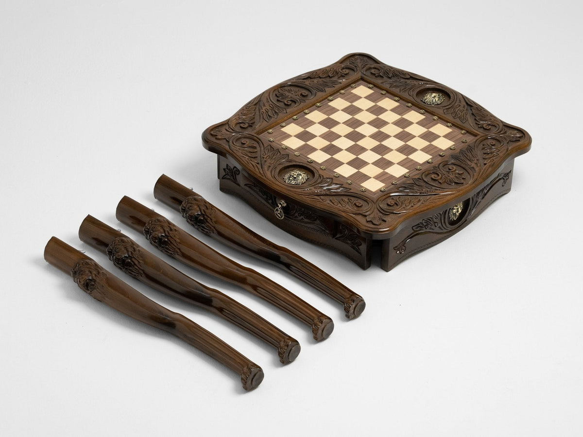 Brass chess pieces set up on the wooden board
