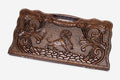 Carved beechwood backgammon board with a striding lion and scrollwork, propped open