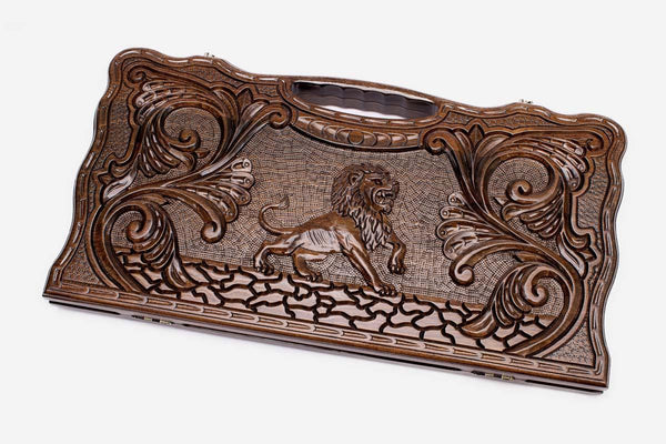 Carved beechwood backgammon board with a striding lion and scrollwork, propped open
