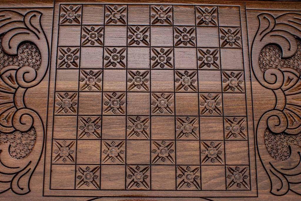 The backgammon board opened to show the wooden playing surface