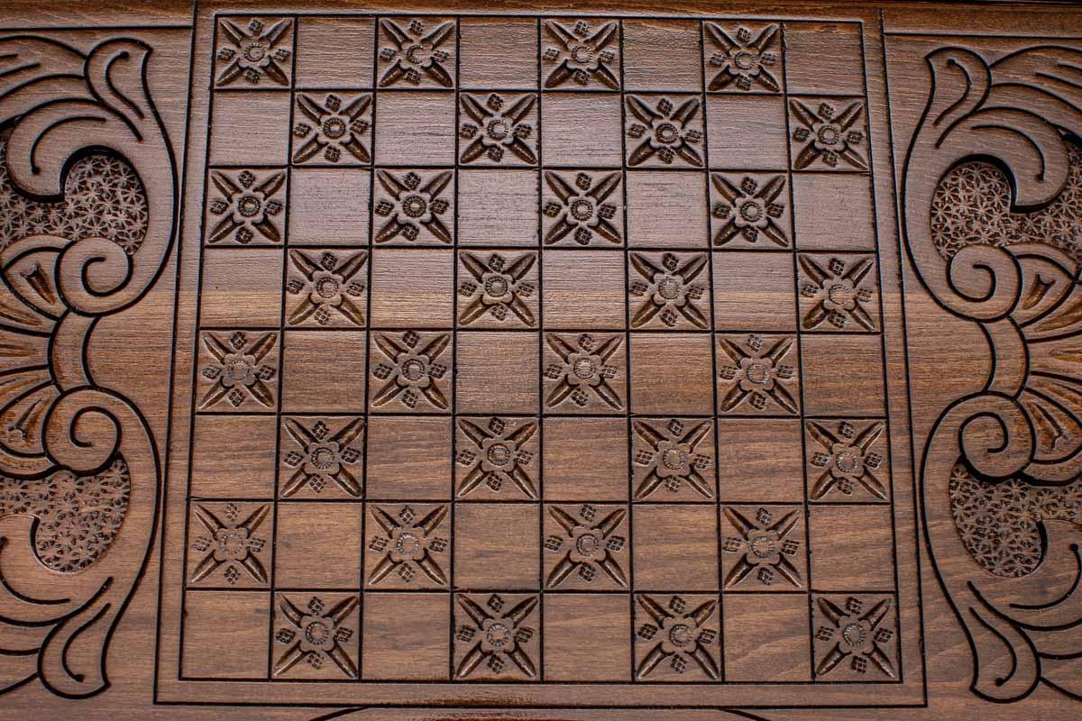 The backgammon board opened to show the wooden playing surface