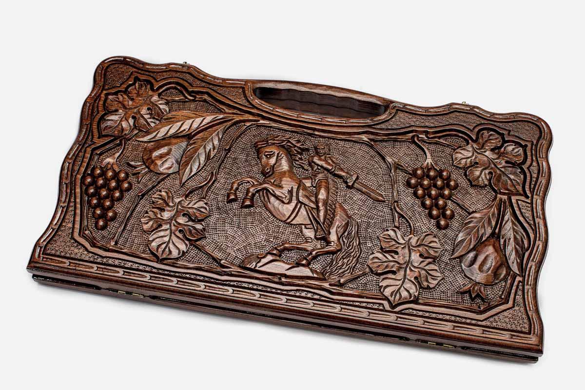 Carved beechwood backgammon board with David of Sasun on horseback amid grapes, propped open