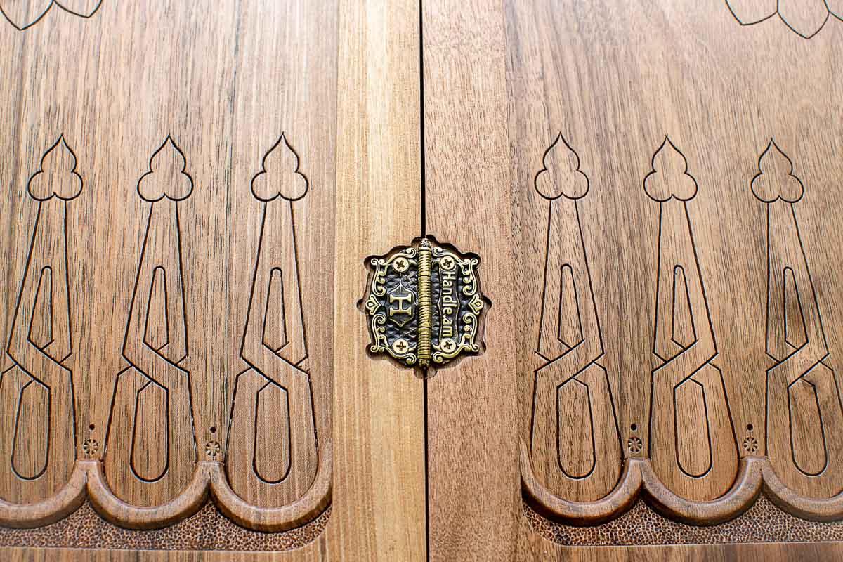 The backgammon board opened to show the wooden playing surface