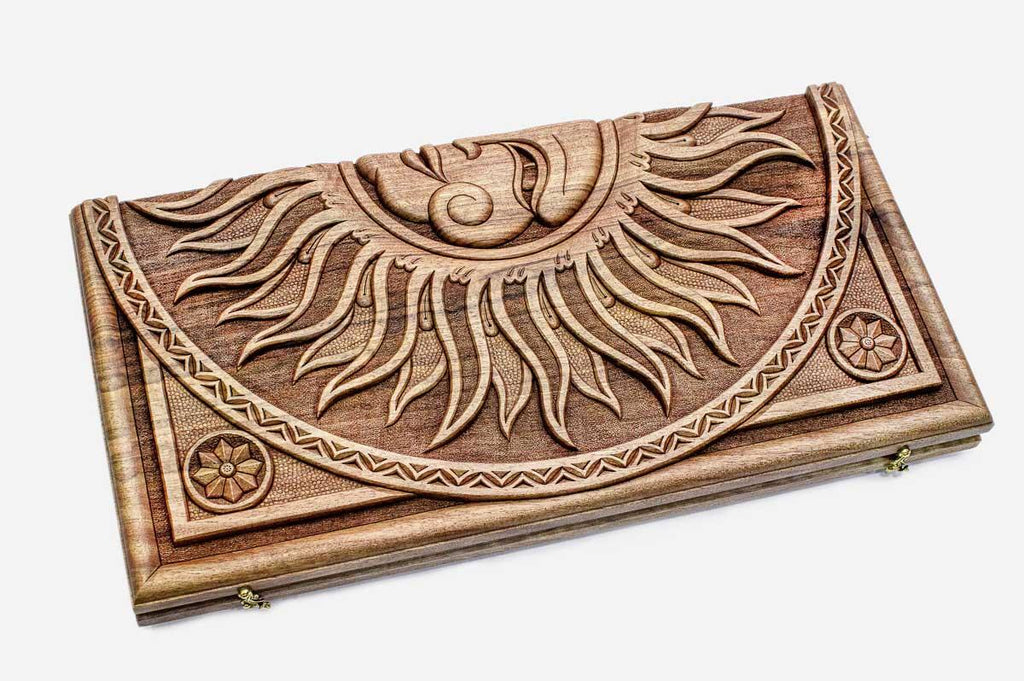 Angled view of the sun master carved walnut backgammon board