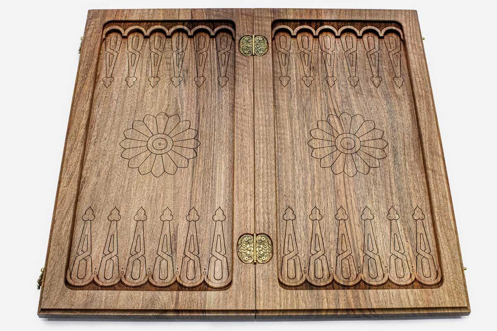 The backgammon board opened to show the wooden playing surface