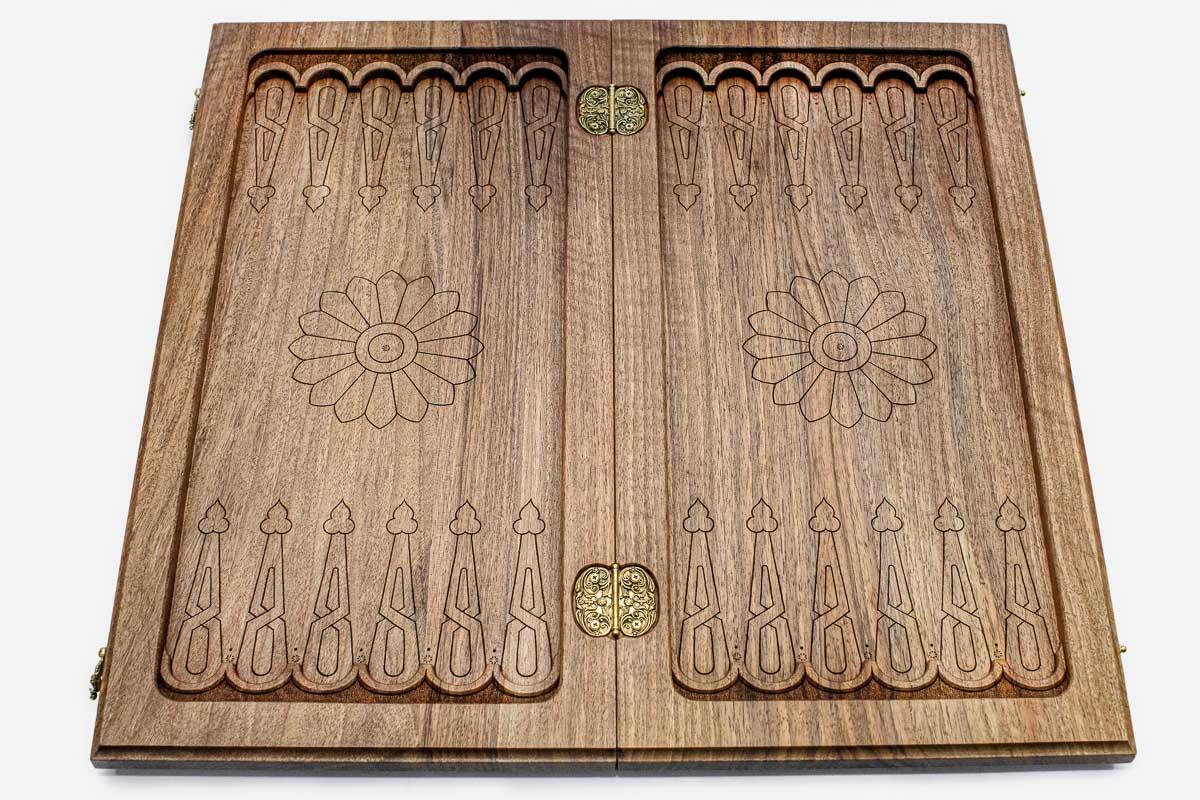 The backgammon board opened to show the wooden playing surface