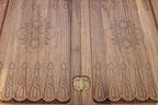 The backgammon board opened to show the wooden playing surface