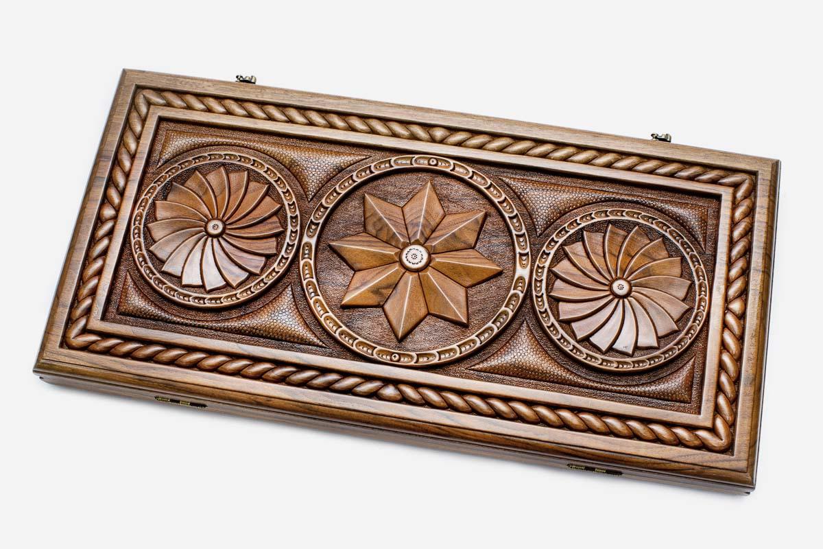 Master-carved walnut backgammon board with an octagon and infinity pattern, propped open