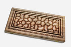 Master-carved walnut backgammon board resembling a bed of river stones, propped open
