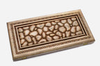 Angled view of the stones master carved walnut backgammon board