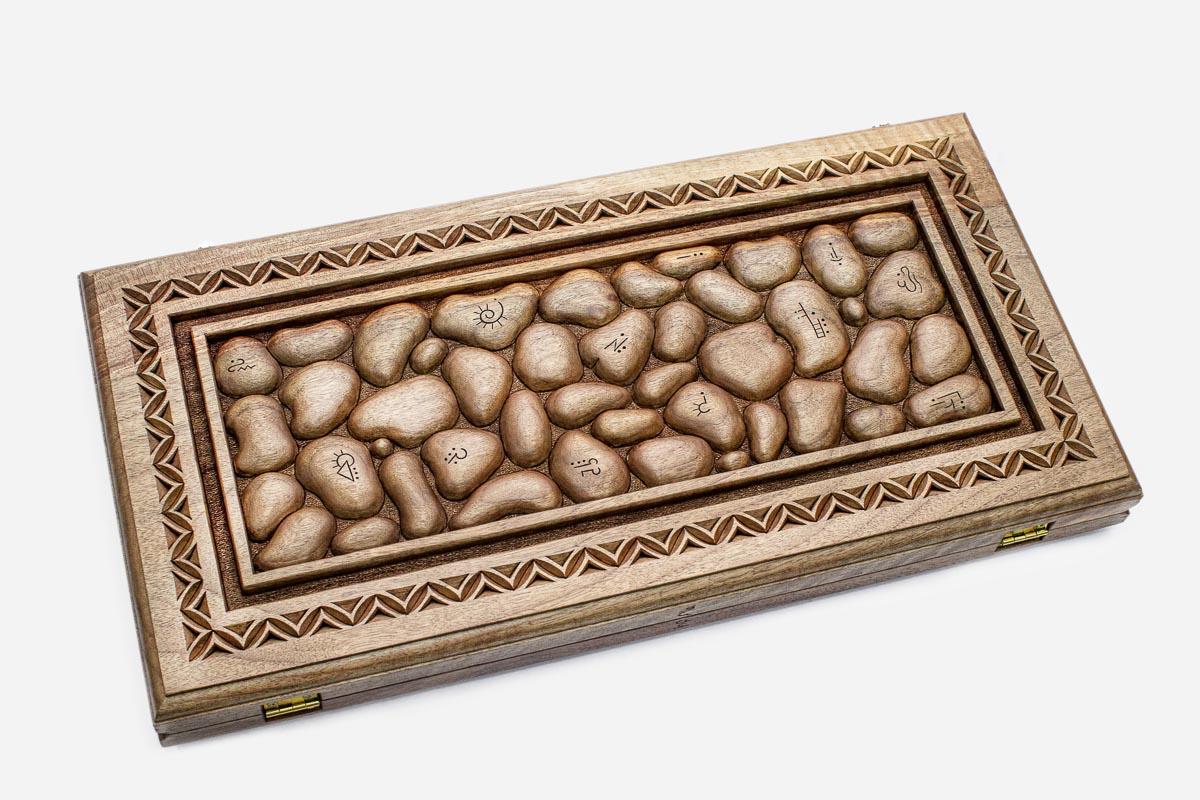 Angled view of the stones master carved walnut backgammon board