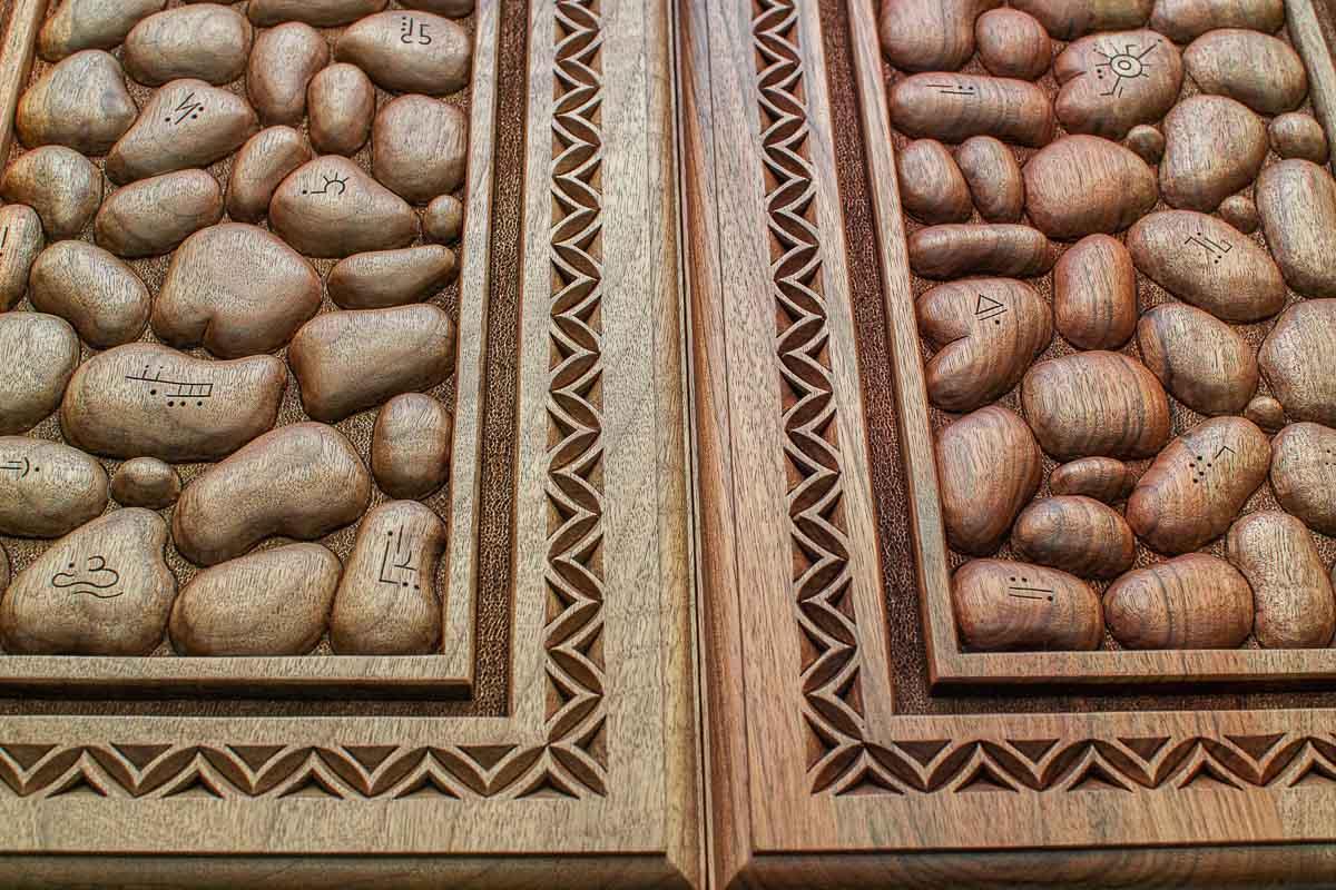 The backgammon board opened to show the wooden playing surface