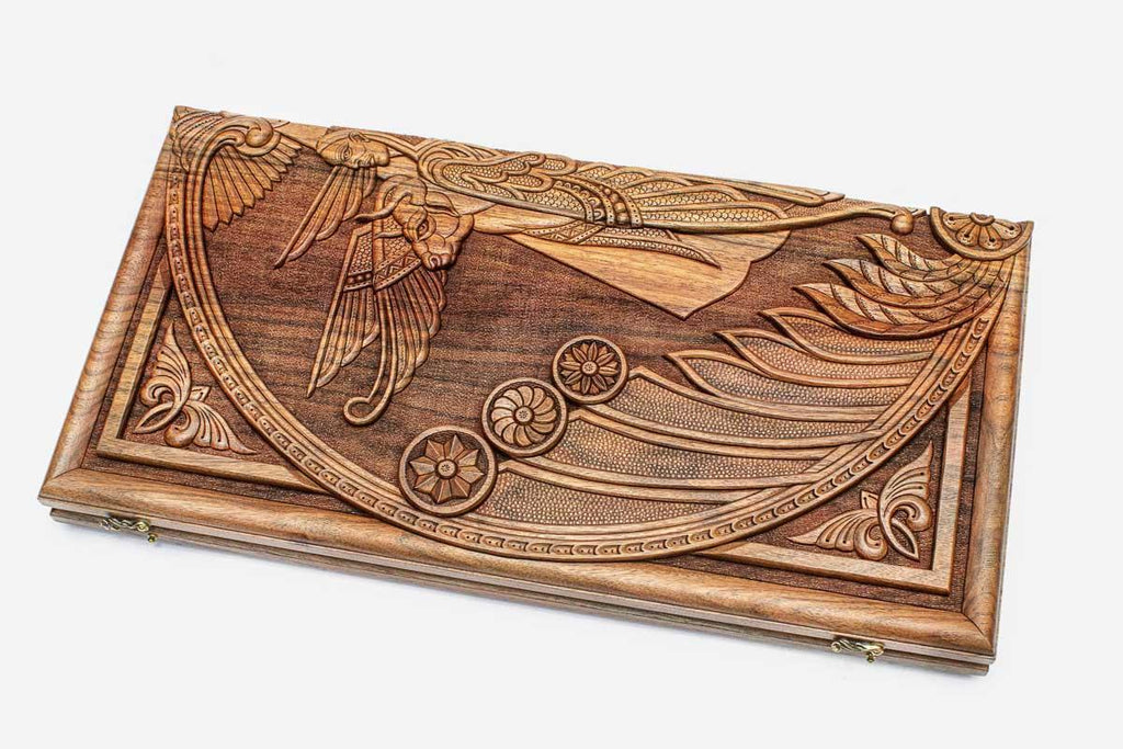 Master-carved walnut backgammon board with a winged cherub, propped open