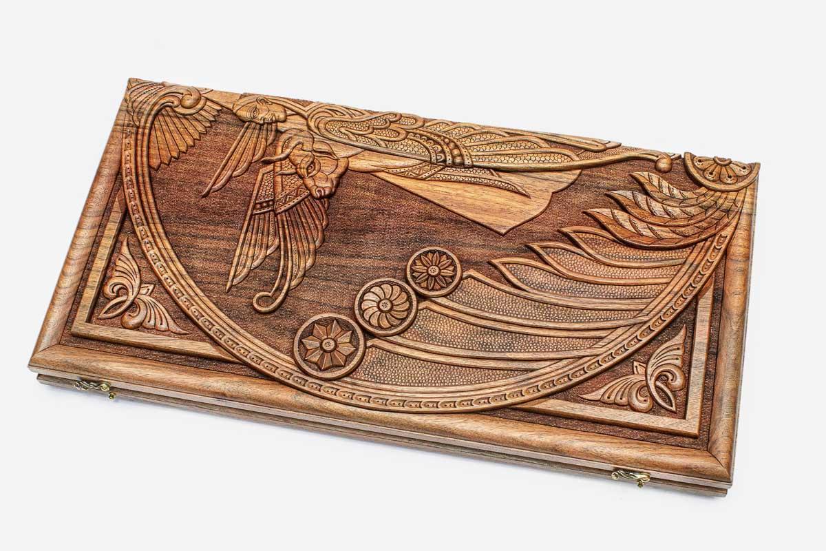 Master-carved walnut backgammon board with a winged cherub, propped open