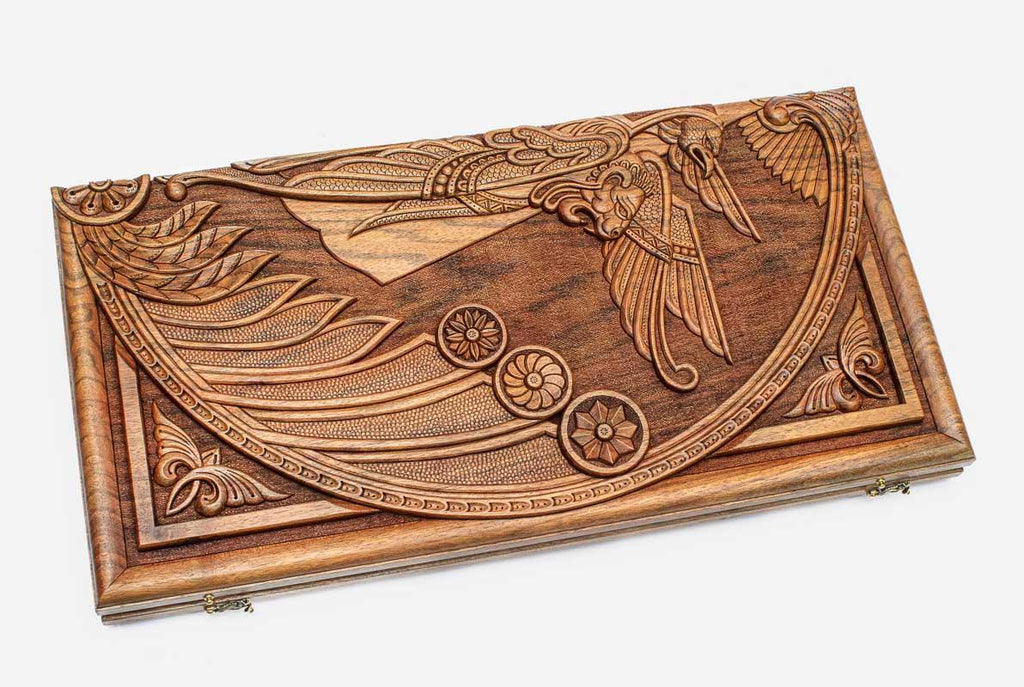 Angled view of the cherub master carved walnut backgammon board