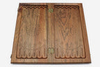 The backgammon board opened to show the wooden playing surface