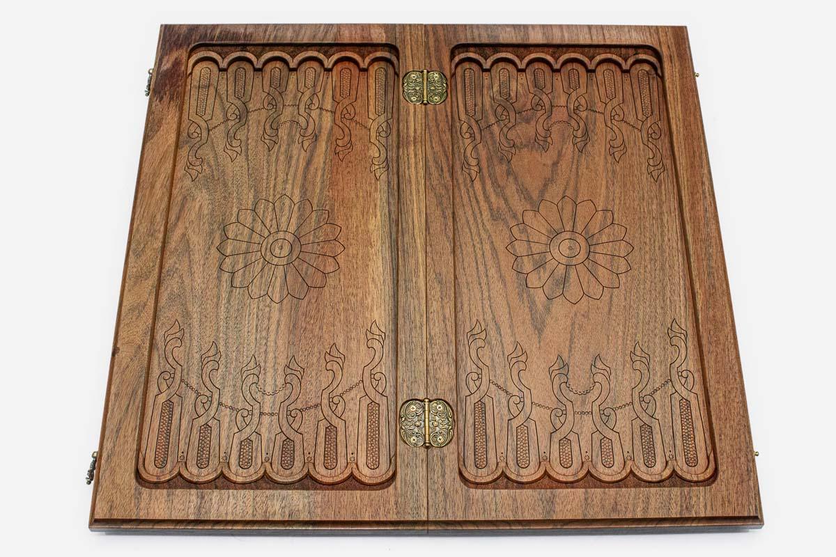 The backgammon board opened to show the wooden playing surface