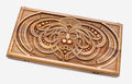 Master-carved walnut backgammon board with a symmetrical carved mask, propped open