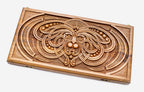 Master-carved walnut backgammon board with a symmetrical carved mask, propped open