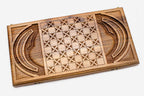 Angled view of the mask master carved walnut backgammon board