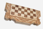 Close-up of the carved royal crown and ribbon banner at the head of the board
