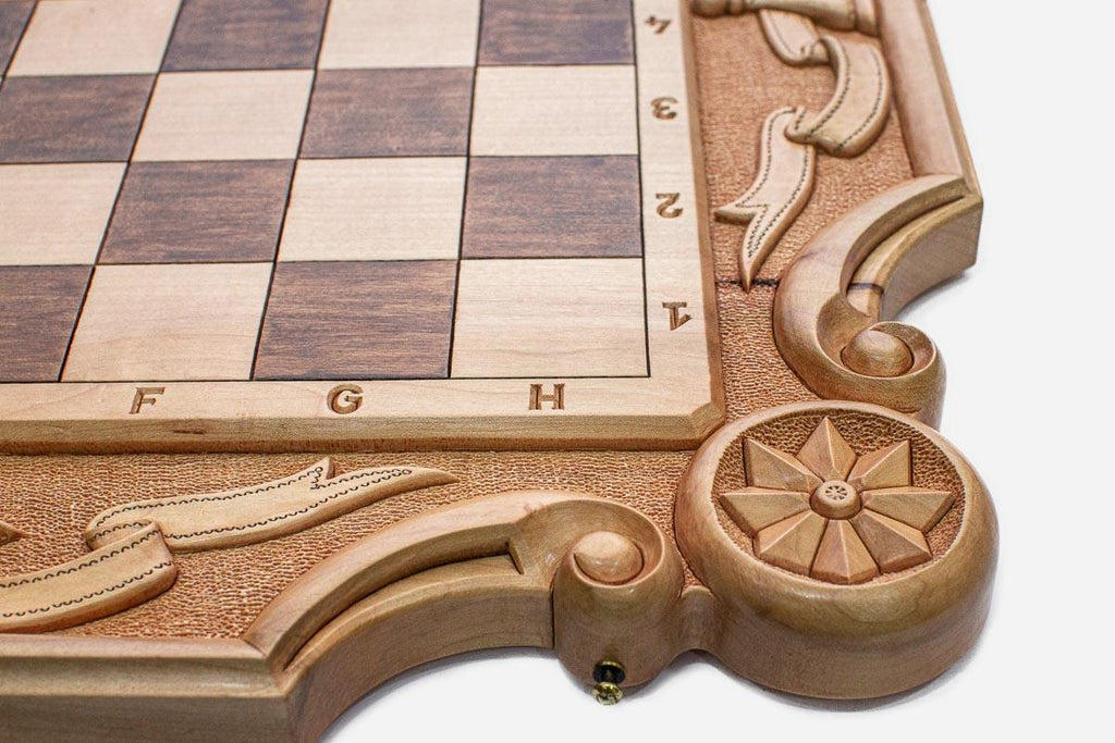 Close-up of the carved corner ornament and scrollwork on the wide border