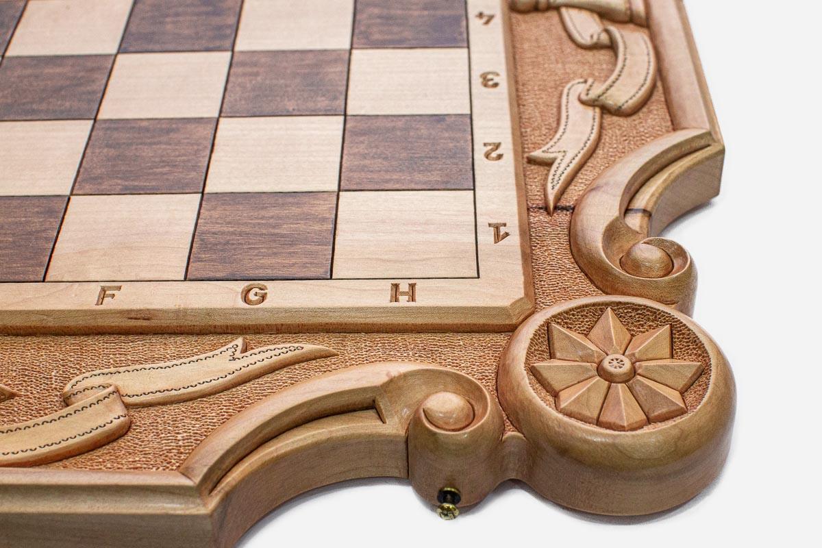 Close-up of the carved corner ornament and scrollwork on the wide border