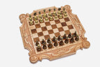 Luxury carved chess set in pale maple with corner ornament, ribbon scrollwork and a carved royal crown, set with bronze-topped pieces