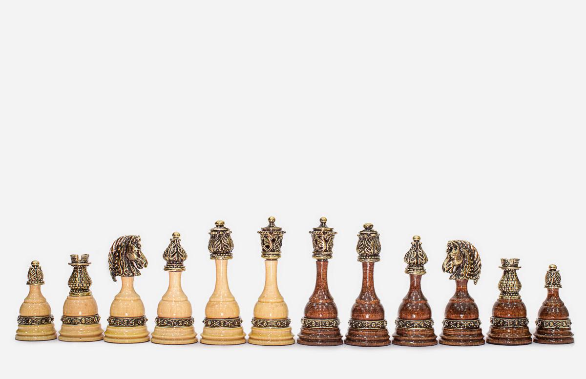 Angled view of the finished carved chess set showing the depth of the relief