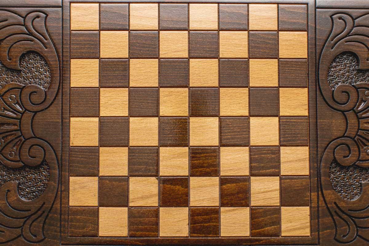 The backgammon board opened to show the wooden playing surface