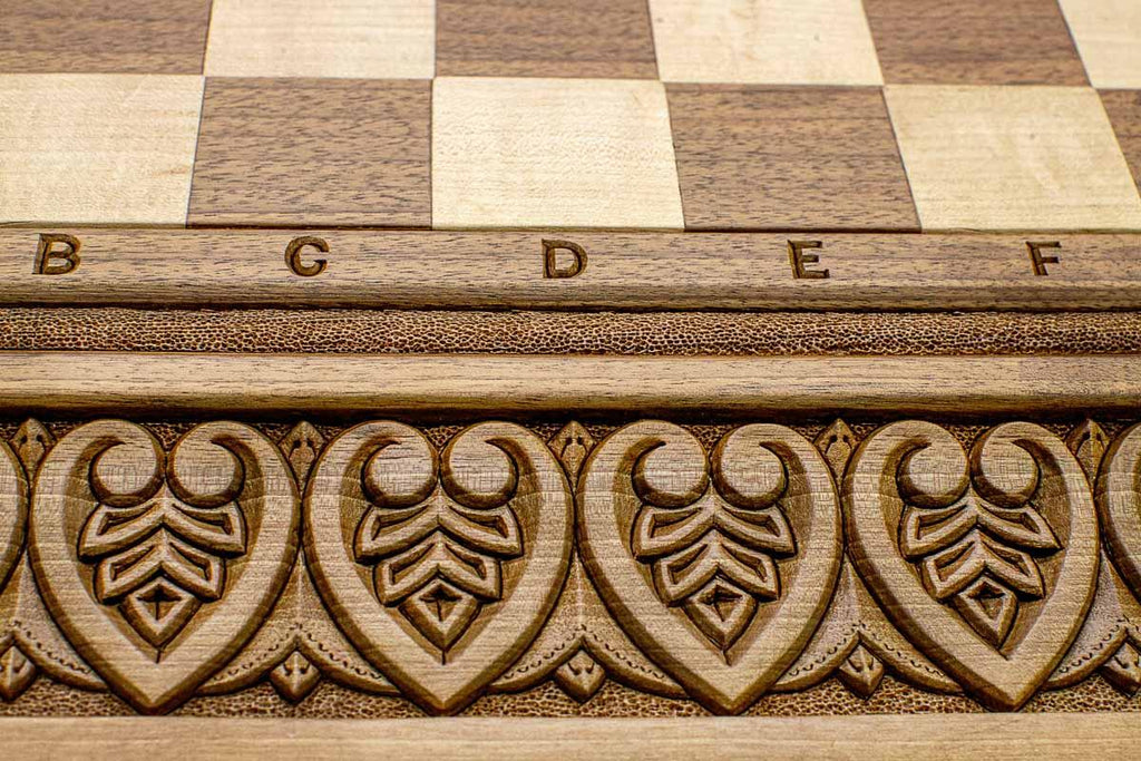 Master-carved royal detailing on solid walnut - chess board close-up
