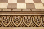 Master-carved royal detailing on solid walnut - chess board close-up