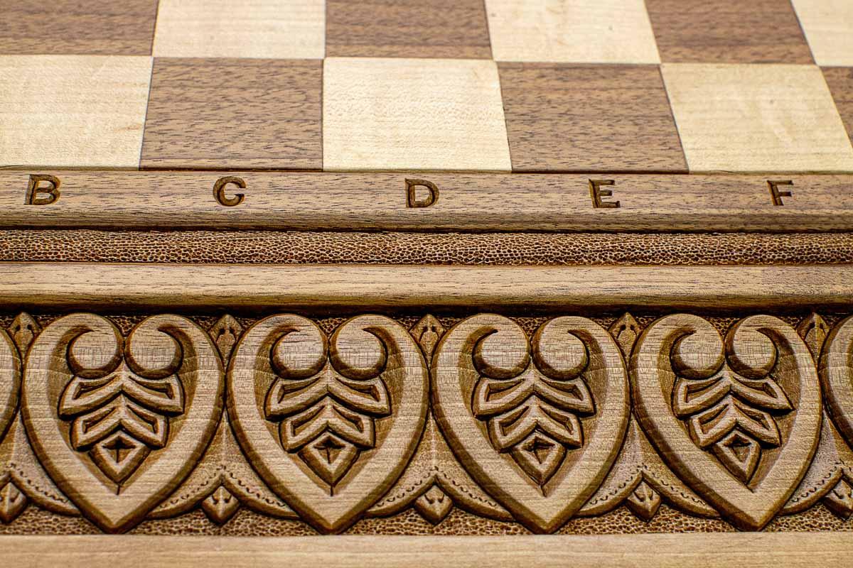 Master-carved royal detailing on solid walnut - chess board close-up