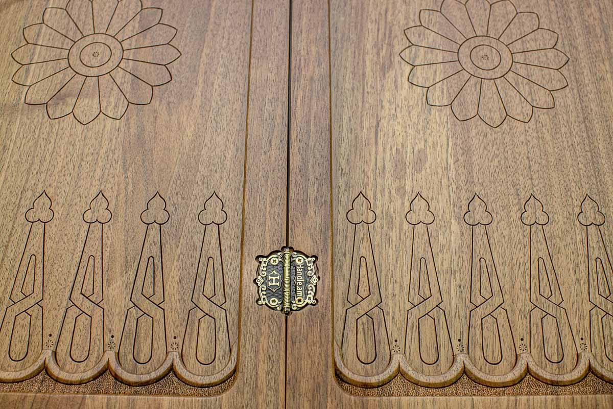 Hand-carved crowned detailing on a luxurious walnut board - angled view
