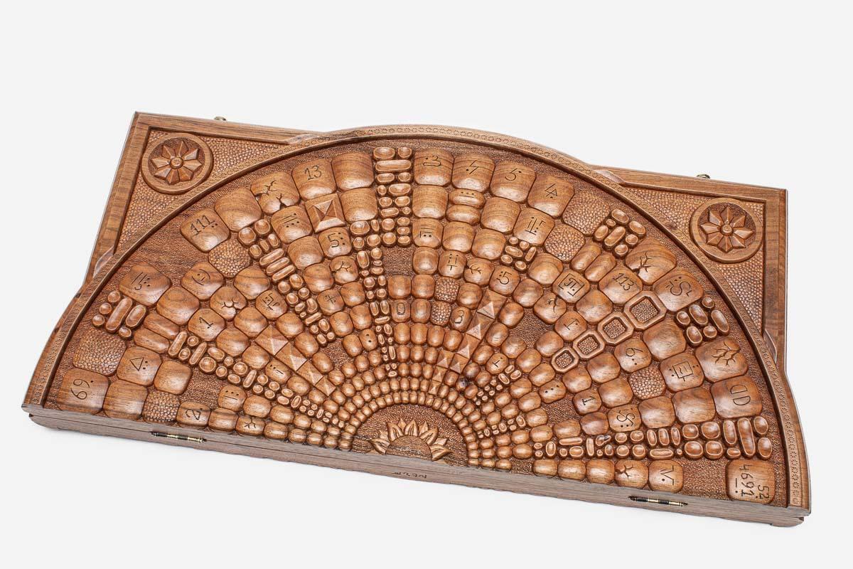 Master-carved walnut backgammon board with a celestial space design, propped open
