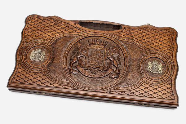Carved beechwood backgammon board with the Georgian coat of arms and bronze accents, propped open