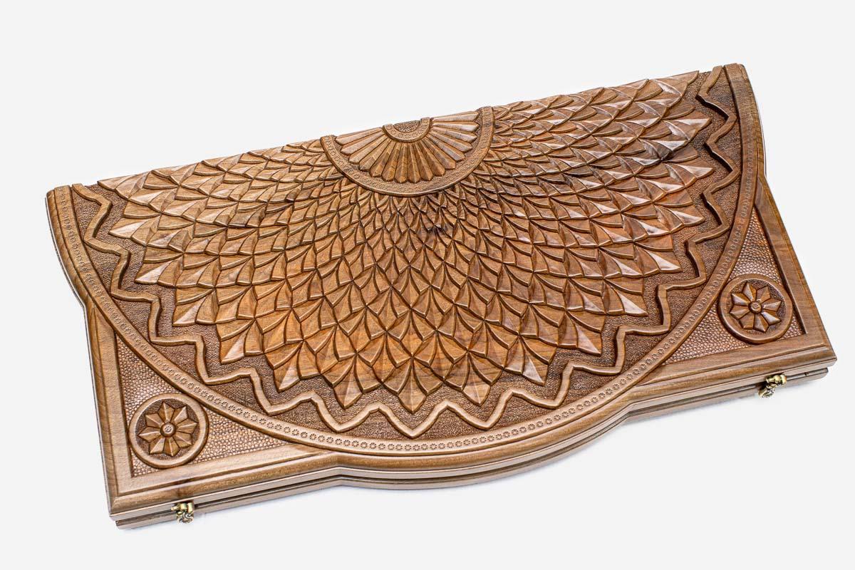 Angled view of the sunflower master carved walnut backgammon board