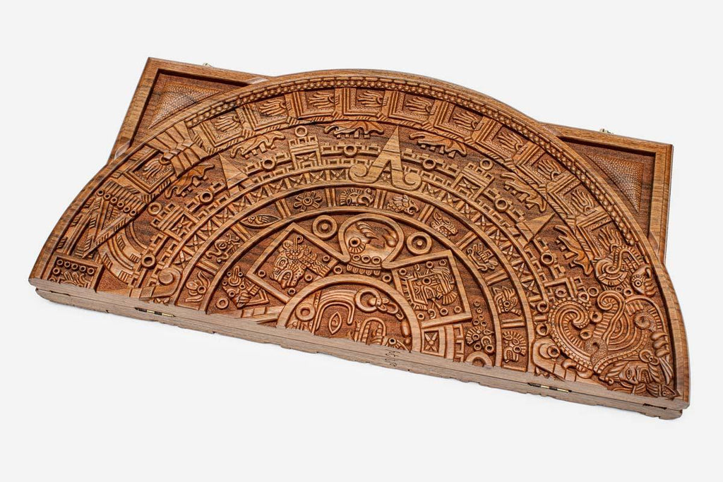 Master-carved walnut backgammon board with the Maya calendar in deep relief, propped open