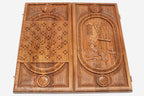 The backgammon board opened to show the wooden playing surface