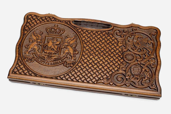 Carved beechwood backgammon board with the Georgian coat of arms and a carry handle, propped open