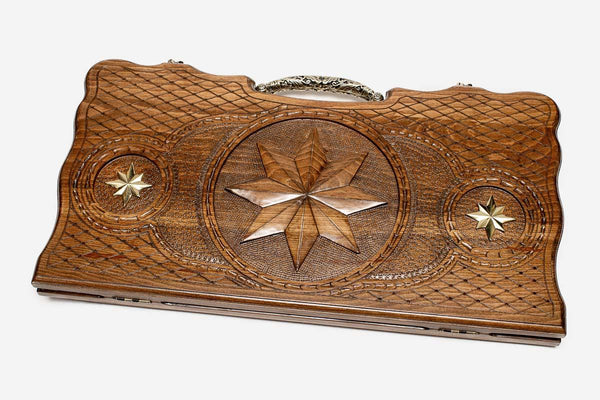Carved beechwood backgammon board with an octagon ornament and ornate bronze handle, propped open