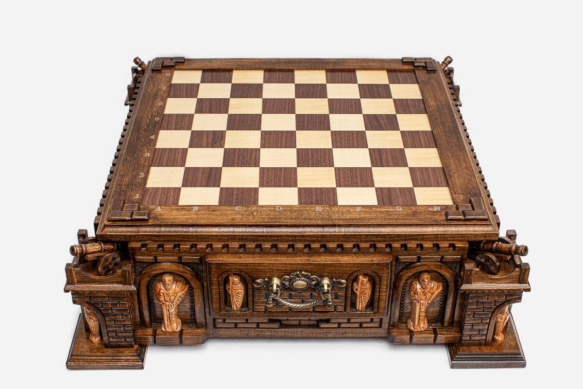 Empty castle chess board showing bronze corner cannons, turrets and brick-carved battlements