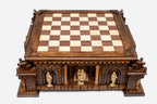 Front view of the castle chess board with carved sentinel figures standing in the arched niches of the fortress base