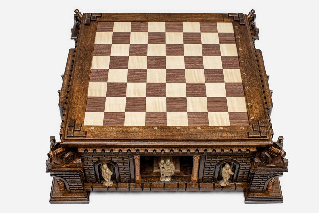 Top angle of the walnut and maple inlaid board raised on the hand-carved castle base