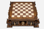Top angle of the walnut and maple inlaid board raised on the hand-carved castle base