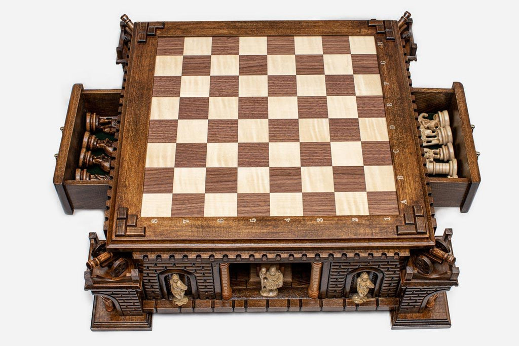Fortress base with both storage drawers open revealing the carved figural chess pieces inside