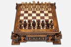 Angled view of the castle chess set fully set up with figural pieces and an open storage drawer